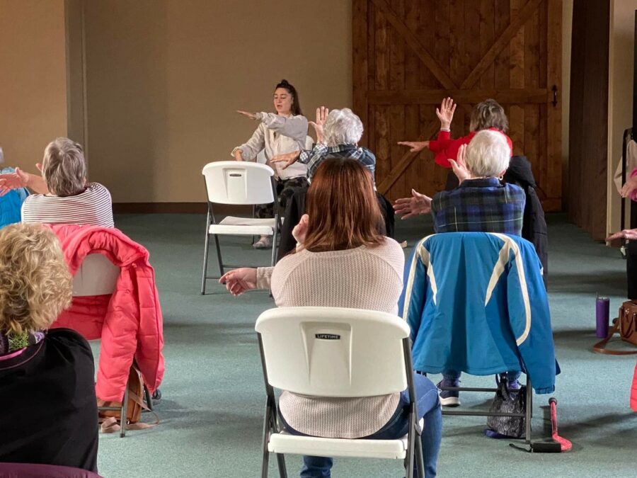 Group of elderly woman engaging in a chair exercise class - Jobs at Pioneer Resources